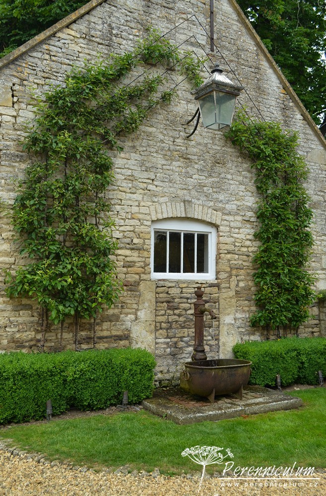 Příběh zahrady v Doyntonu 7 Protor po pravé straně domu a zároveň zadní vchod do domu slouží jako parkoviště. U stěny bývalých stájí našla místo stará pumpa.
